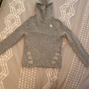 Hooded sweater from Abercrombie Kids. Cris cross detail by the bottom.